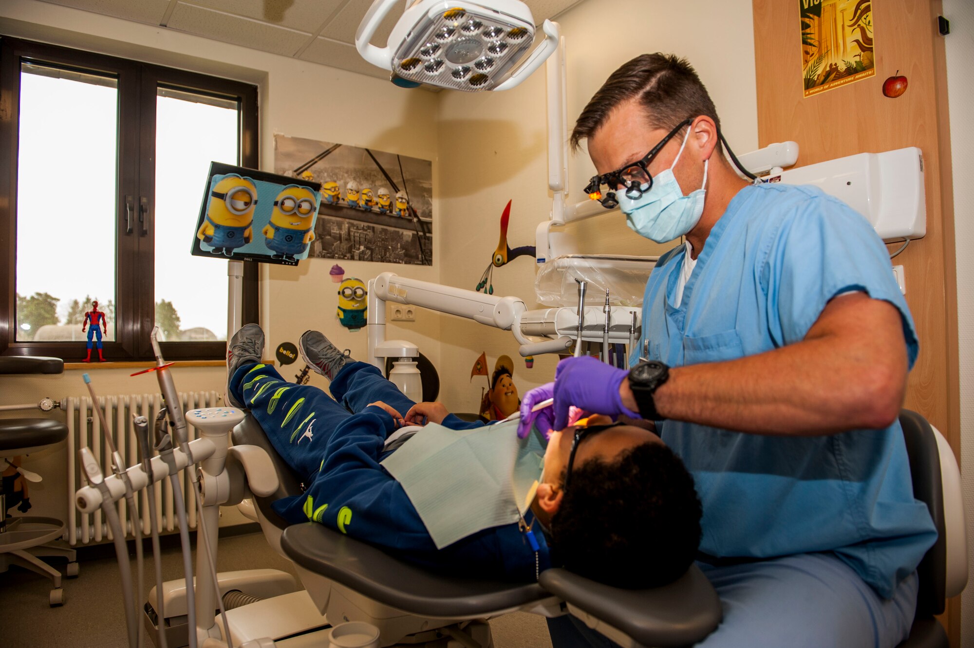 U.S. Air Force Capt. Jon Federspiel, a 52nd Dental Squadron general dentist, inspects the state of a 52nd Fighter Wing child’s oral hygiene during the dental clinic’s semi-annual children’s walk-in at Spangdahlem Air Base, Germany, April 22, 2016. More than 50 children received dental care, examinations and oral hygiene tips during at the clinic. (U.S. Air Force photo by Airman 1st Class Timothy Kim/Released)