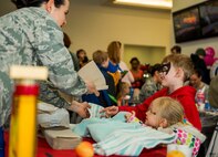 U.S. Air Force Capt. Denise Campbell, 52nd Aerospace Medicine Squadron health promotion dietitian, right, interacts with Cael and Keira Dell, children of U.S. Air Force Staff Sgt. Brady Dell, a 52nd Component Maintenance Squadron jet engine intermediate maintenance crew supervisor, during the Spring Fling event in the Base Exchange at Spangdahlem Air Base, Germany, April 15, 2016. The EFMP works with military families with special needs children to address and accommodate their specific needs at their installation. (U.S. Air Force photo by Airman 1st Class Timothy Kim/Released)