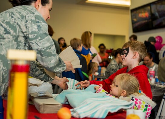 U.S. Air Force Capt. Denise Campbell, 52nd Aerospace Medicine Squadron health promotion dietitian, right, interacts with Cael and Keira Dell, children of U.S. Air Force Staff Sgt. Brady Dell, a 52nd Component Maintenance Squadron jet engine intermediate maintenance crew supervisor, during the Spring Fling event in the Base Exchange at Spangdahlem Air Base, Germany, April 15, 2016. The EFMP works with military families with special needs children to address and accommodate their specific needs at their installation. (U.S. Air Force photo by Airman 1st Class Timothy Kim/Released)