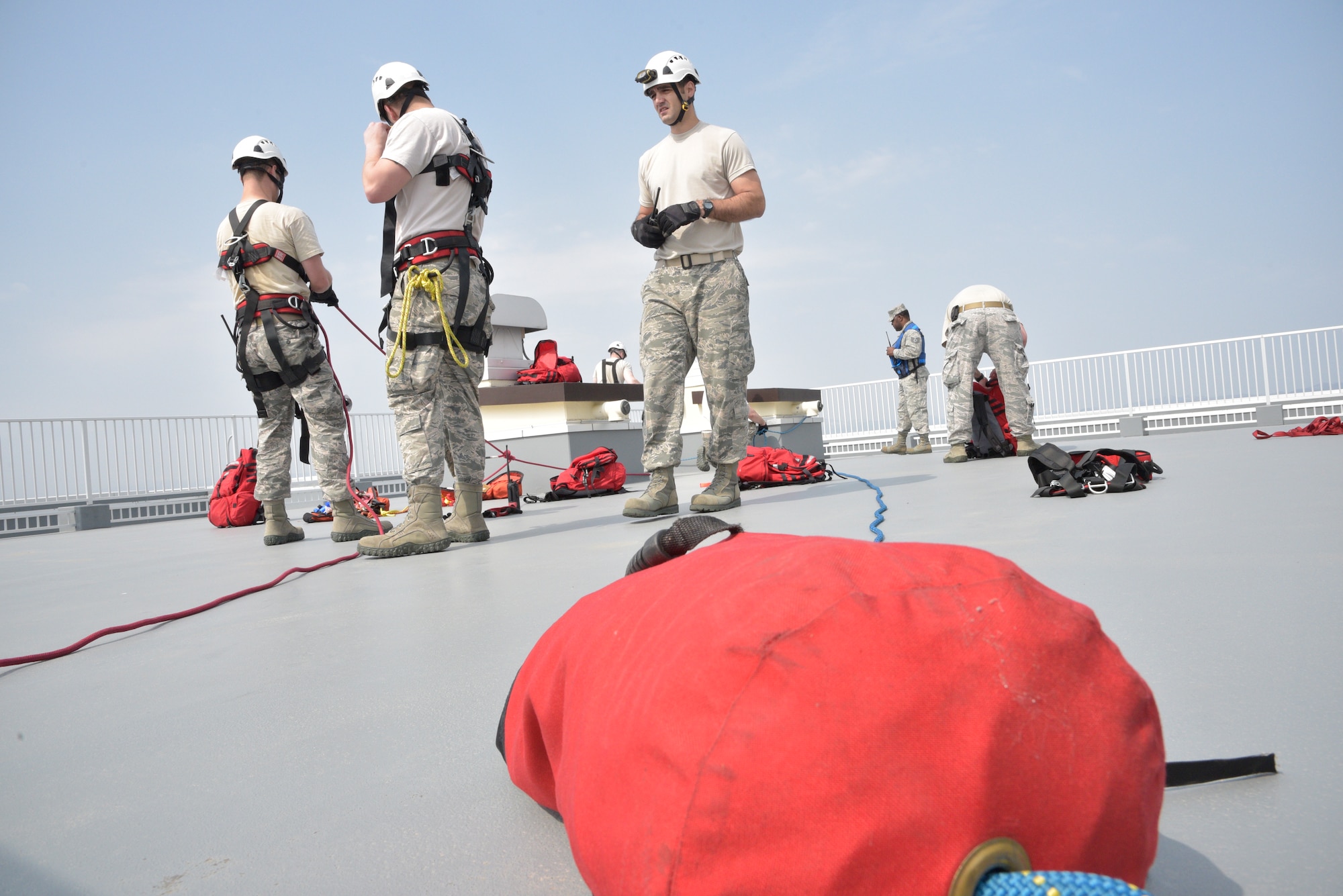 Airmen from the 35th Civil Engineer Squadron Fire Department secure harnesses to a roof during an emergency management exercise at Misawa Air Base, Japan, April 26, 2016. After a simulated 8.2 magnitude earthquake struck, several Airmen and civilians simulating injuries were in need of rescue and required the use of rappelling to reach them. (U.S Air Force photo by Senior Airman Patrick S. Ciccarone)
