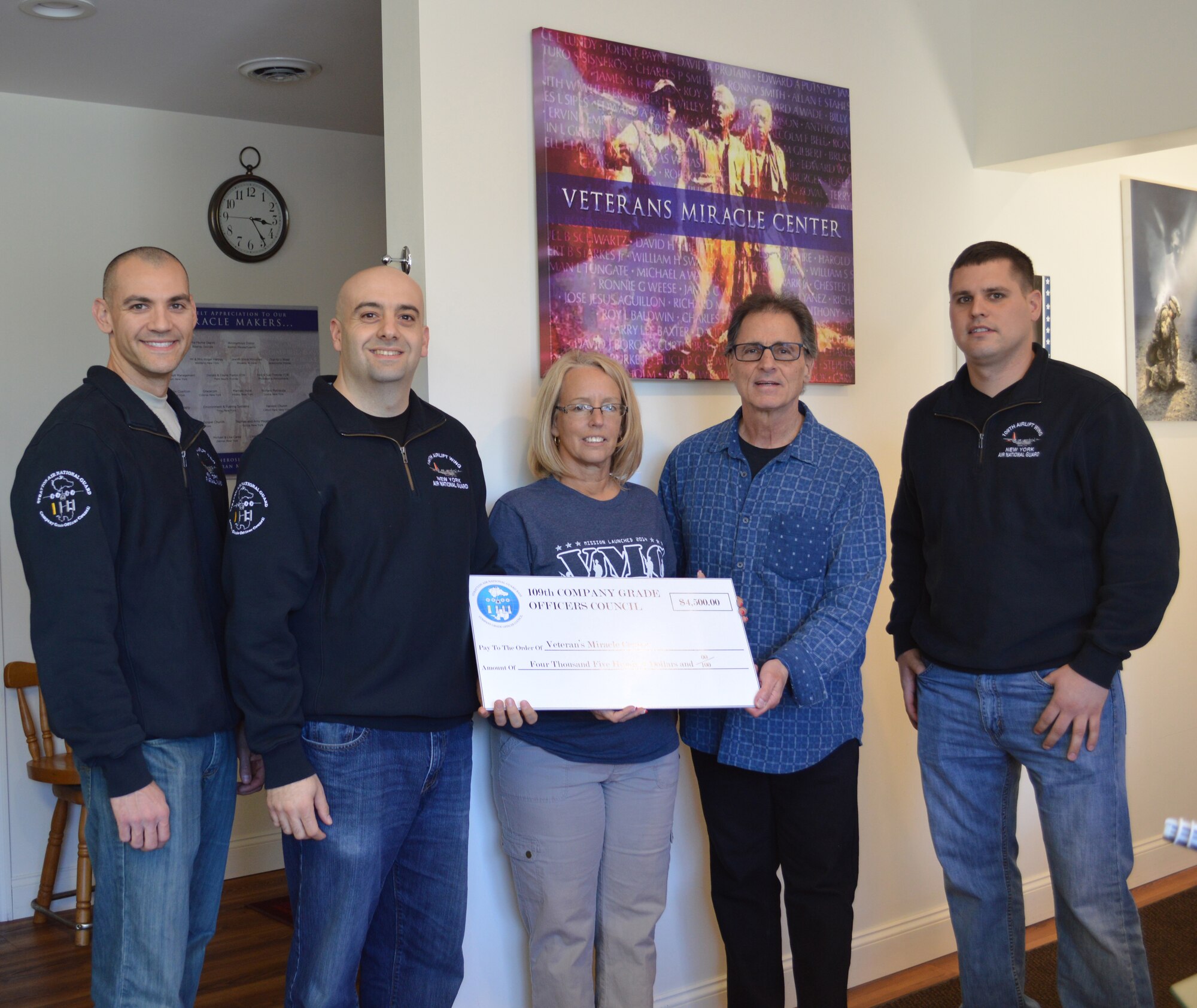 The 109th Company Grade Officers' Council donated $4,500 to the Veterans Miracle Center in Albany, New York, on April 14, 2016, from funds raised during the coucil's annual golf tournament in September. Pictured are (from left) 1st Lt. Jared Semerad; Capt. James Vendetti, CGO Council president; Melody Burns, VMC Director of Operations; Barry Feinman, Jezreel International CEO; and Capt. Shawn Rulsion. (U.S. Air National Guard photo by Tech. Sgt. Catharine Schmidt/Released)