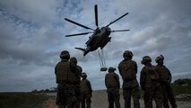 Marines conduct a helicopter support team exercise at Marine Corps Air Station Futenma, Okinawa, Japan, April 22, 2016. The Marines are landing support specialists, commonly referred to as red patchers, with Landing Support Detachment, 3rd Transportation Support Battalion, Combat Logistics Regiment 3, 3rd Marine Logistics Group, III Marine Expeditionary Force.