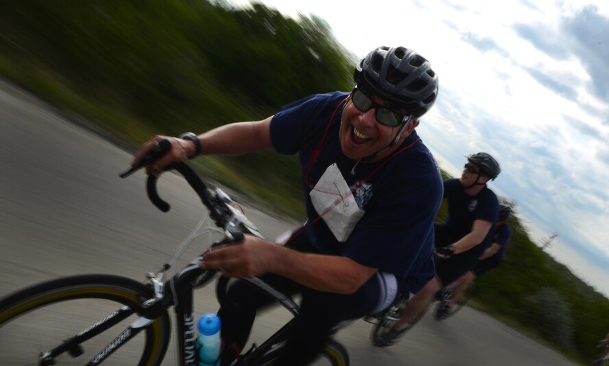 A competitor smiles as he bikes during the Adventure Race XII in Del Rio, Texas, April 23, 2016. The biking portion of the Adventure Race stretches 23 miles from Laughlin Air Force Base to the Laughlin Southwinds Marina off of Lake Amistad. (U.S. Air Force photo by Senior Airman Ariel D. Partlow)