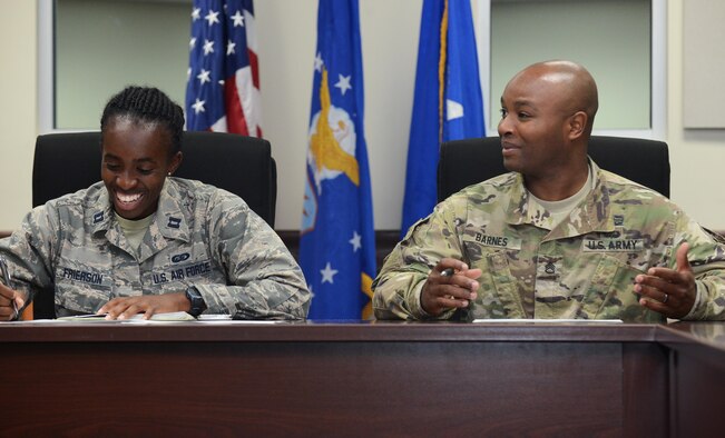 U.S. Air Force Capt. Tina Frierson, 36th Wing sexual assault response coordinator, left, and U.S. Army Staff Sgt. Keith Barnes, Task Force Talon intelligence section NCO in charge, discuss results of a sexual assault prevention and response competition April 27, 2016, at Andersen Air Force Base, Guam. To conclude the Sexual Assault Awareness and Prevention Month, Task Force Talon, 36th Wing, Joint Region Marianas and Marine Corps Activity Equal Opportunity/SAPR offices conducted a joint competition to promote esprit de corps and bring awareness to SAPR programs. (U.S. Air Force photo by Airman 1st Class Arielle Vasquez/Released)