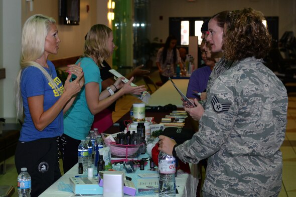 Airmen receive information on wellness products from vendors at the Health and Fitness Fair April 27, 2016, at Andersen Air Force Base, Guam. Vendors raised awareness and encouraged Airmen and their families to live a healthy lifestyle. (U.S. Air Force photo by Airman 1st Class Jacob Skovo)