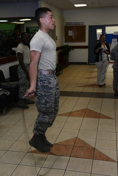 Airman Kevin Chandler, 36th Medical Operations Squadron public health technician, jumps rope during a competition at the Health and Fitness Fair April 27, 2016, at Andersen Air Force Base, Guam. The competition required participants to execute pushups, jump rope and conduct abdominal fitness exercises. (U.S. Air Force photo by Airman 1st Class Jacob Skovo)