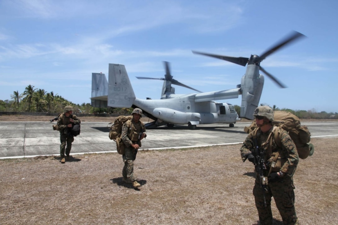 Marines disembark from an MV-22 Osprey after landing at an airstrip in Panay, Philippines, during Exercise Balikatan, Monday, April 11, 2016. The Marines were acting as a follow-up force for an earlier amphibious landing by Filipino marines. (Stars and Stripes/Wyatt Olson)