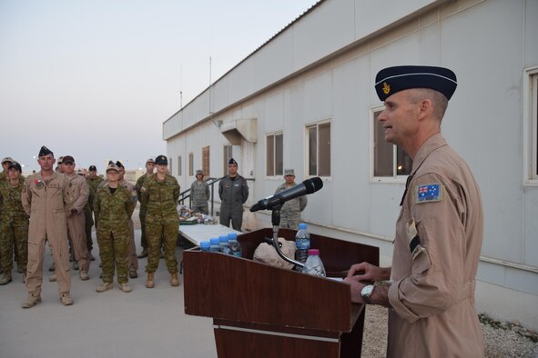 Air Commodore Antony Martin (right), The Commander Air Task Group, gave the closing remarks at the ANZAC Day ceremony at an undisclosed location in Southwest Asia, April 25, 2016. A typical ANZAC Day National Ceremony may include the following features: an introduction, a hymn, a prayer, an address, the laying of wreaths, a recitation, the Last Post, a period of silence, the playing of either the Rouse or the Reveille, and the National Anthem according to the Australian War Memorial website. The event here mirrored ANZAC Day events that took place in Australia and New Zealand. (U.S. Air Force photo by Tech. Sgt. Carlos J. Trevino/Released)

