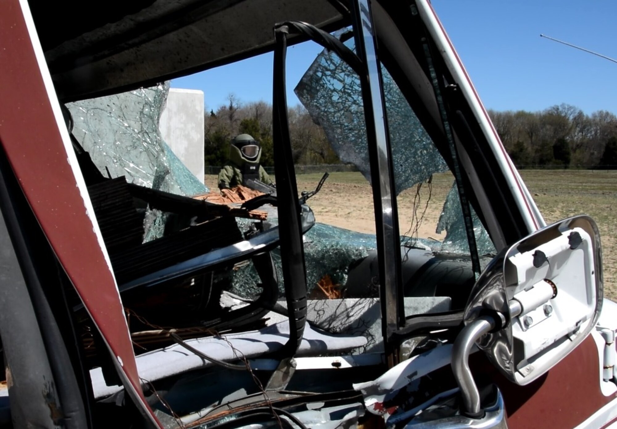 Staff Sgt. John Nelson, 512th Explosive Ordnance Flight, emerges from a secure detonation area after simulating removal of a mock improvised explosive device during a training exercise April 3, 2016 at Dover Air Force Base, Delaware. The bomb suit Nelson wore weighs approximately 85 lbs and is designed to provide the wearer the highest degree of protection and operational flexibility. (U.S. Air Force photo/Staff Sgt. Joe Yanik)