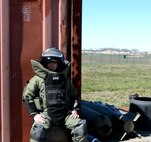 Staff Sgt. John Nelson, 512th Explosive Ordnance Flight, rests after completing his training exercise involving identifying, inspecting and rendering safe a simulated improvised explosive device April 3, 2016 at Dover Air Force Base, Delaware. Were this a real world situation, the device would be transferred to a secure location for disposal after it was rendered safe. (U.S. Air Force photo/Staff Sgt. Joe Yanik)