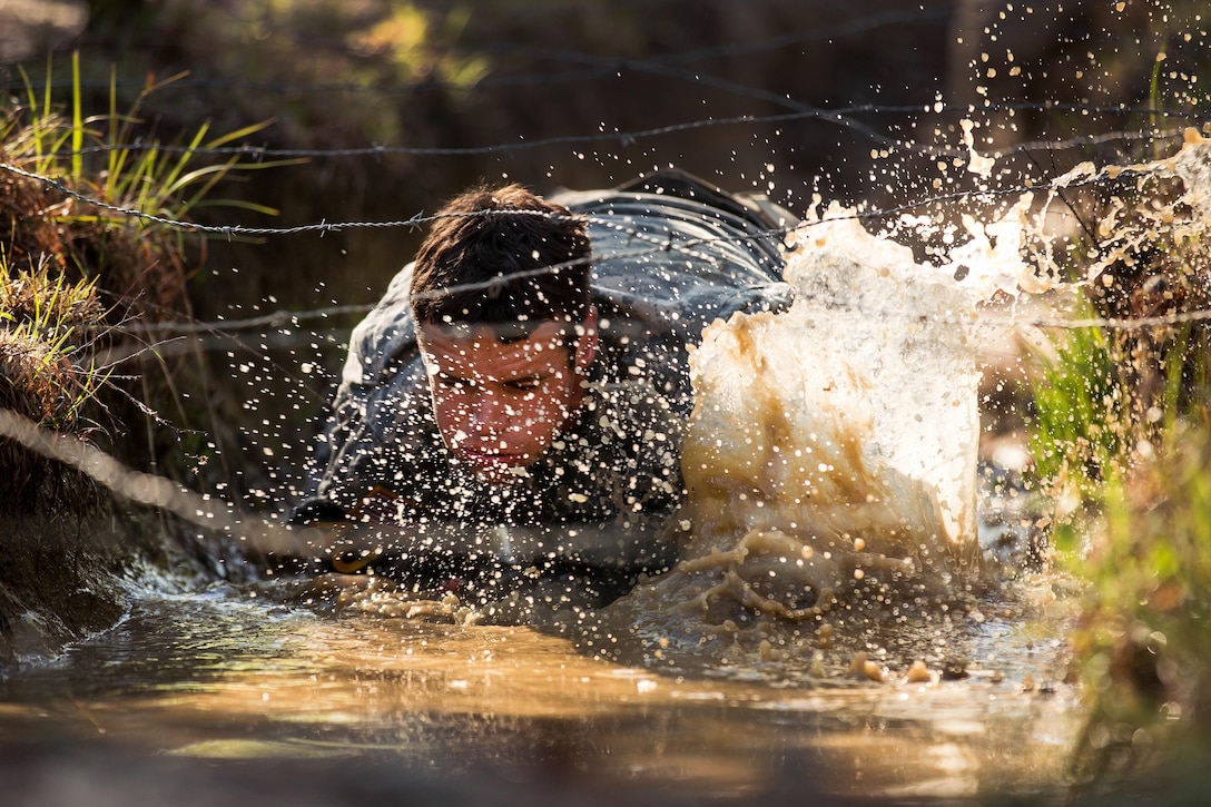 Army Staff Sgt. John Breda splashes through the belly crawl obstacle, on Darby Queen obstacle course, during the 2016 Best Ranger competition at Fort Benning, Ga., April 17, 2016. Breda is assigned to the 75th Ranger Regiment. The 33rd annual David E. Grange Jr. Best Ranger Competition 2016 was a three-day event consisting of challenges to test competitor's physical, mental, and technical capabilities. Army photo by Sgt. Jesus Guerrero