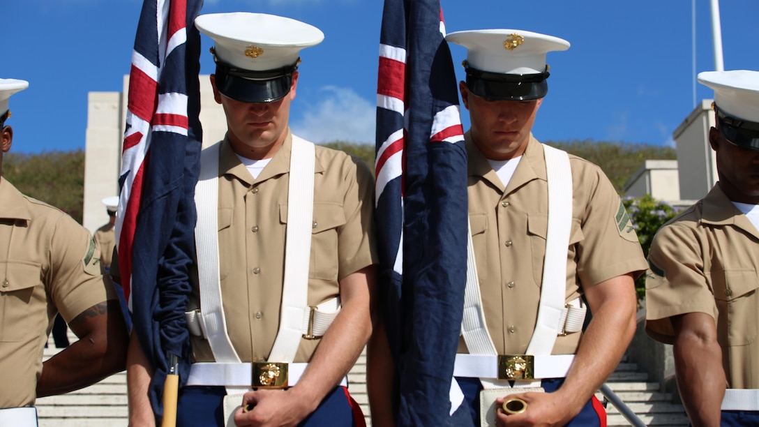 A Marine color guard, featuring the Australia and New Zealand national colors, bow their heads during prayer at the National Memorial Cemetery of the Pacific in Oahu, Hawaii, April 25, 2016. This is the 44th year U.S. Marines have participated in the commemoration of the Australia New Zealand Army Corps Day, highlighting a long-lasting friendship between the three countries. 