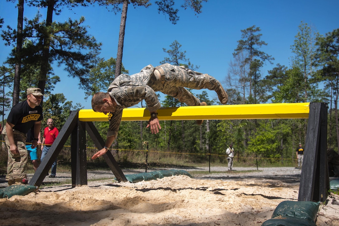 Army 1st Lt. Christopher Jarret dives over the combat roll obstacle, on Darby Queen obstacle course, during the Best Ranger competition at Fort Benning, Ga., April 17, 2016. Jarret is assigned to the 7th Infantry Division. Army photo by Sgt. Jesus Guerrero