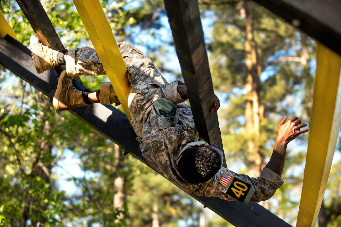 Army Sgt. Sheldon Evans negotiates the weaver obstacle at the Darby Queen obstacle course during the Best Ranger Competition 2016 at Fort Benning, Ga., April 17, 2016. Evans is assigned to the 75th Ranger Regiment. Army photo by Spc. Steven Hitchcock