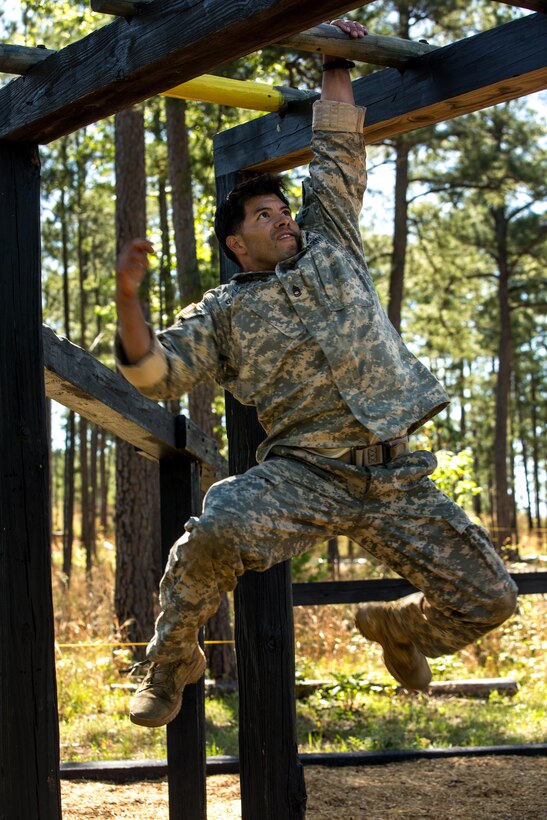 Army Staff Sgt. Eric Guevera negotiates the horizontal ladder obstacle at the Darby Queen obstacle course during the Best Ranger Competition 2016 at Fort Benning, Ga., April 17, 2016. Guevera is assigned to the 25th Infantry Division. Army photo by Spc. Steven Hitchcock