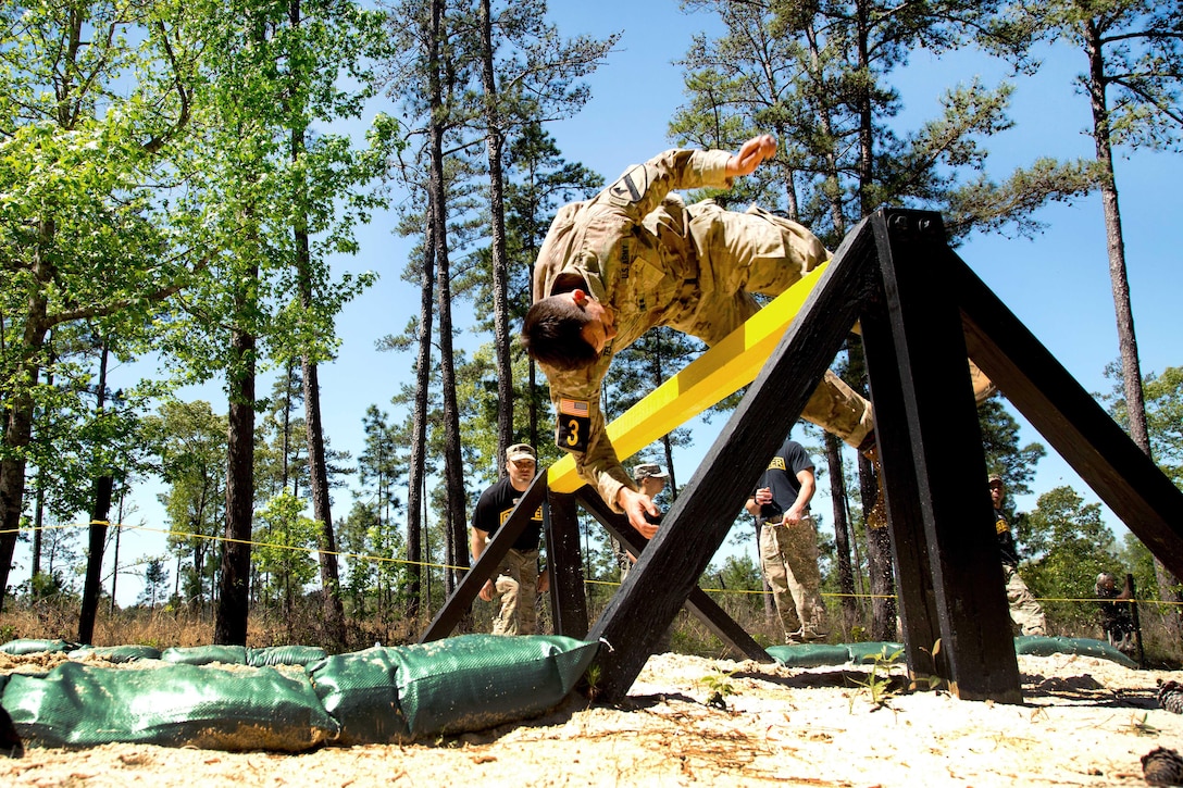 Army Capt. James Teskey flips over the combat roll obstacle at the Darby Queen obstacle course, during the Best Ranger Competition 2016 at Fort Benning, Ga., April 17, 2016. Teskey is assigned to the 2nd Infantry Division. Army photo by Spc. Steven Hitchcock