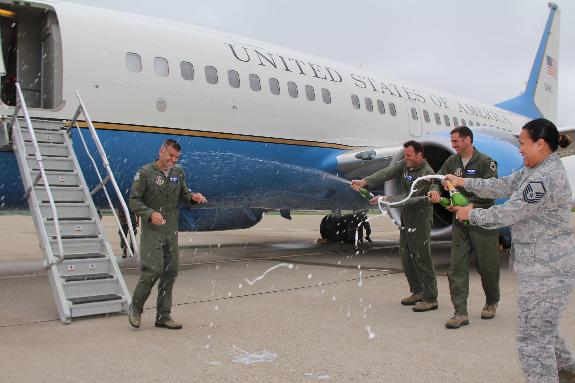 Col. Sean Pierce, outgoing 932nd Operation Group commander, is sprayed down with bubbles, enthusiasm and laughter by his unit members after he completed his "fini flight", or final C-40C flight on the distinguished visitor airlift plane.  The plane is used to transport DV worldwide as part of the 932nd Airlift Wing, under 22nd Air Force, Air Force Reserve Command.  (U.S. Air Force photo by Maj. Stan Paregien)