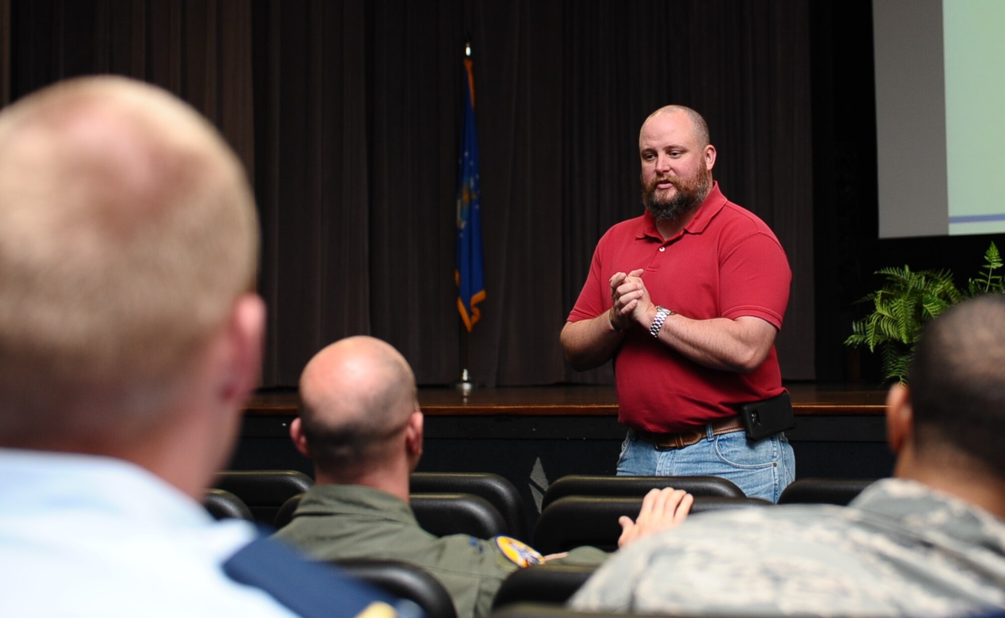 John Lindell, 14th Flying Training Wing Safety Office, speaks to Team BLAZE motorcycle drivers gathered together during one of two safety briefings April 22 in the Kaye Auditorium at Columbus Air Force Base. The Air Education and Training Command used the briefings to help push Airmen to be more vigilant with their driving habits and focused on several recent fatalities involving cyclists who were speeding.(U.S. Air Force photo/Senior Airman Kaleb Snay)