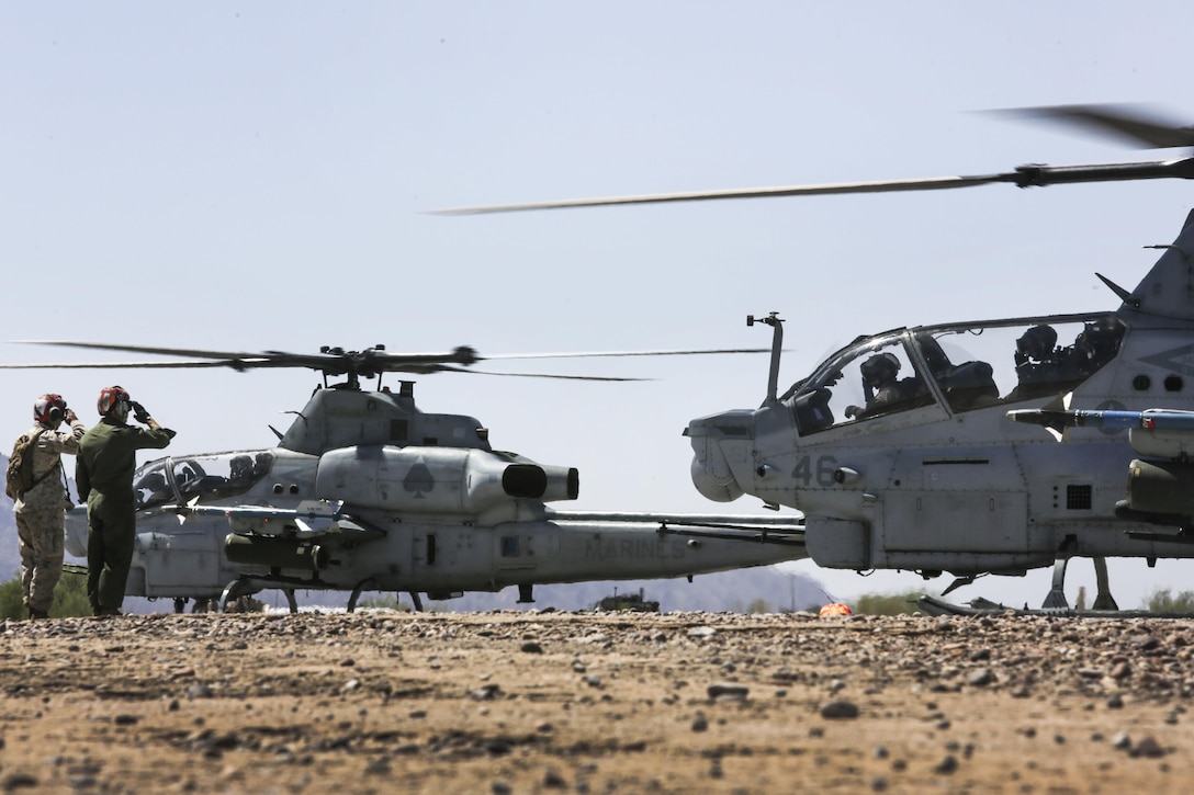 Marines salute an AH-1Z Viper helicopter during takeoff as a part of Final Exercise 3, Weapons and Tactics Instructor course 2-16 at Stoval Airfield, near Yuma, Ariz., April 23, 2016. Marine Corps photo by Lance Cpl. Zachary M. Ford