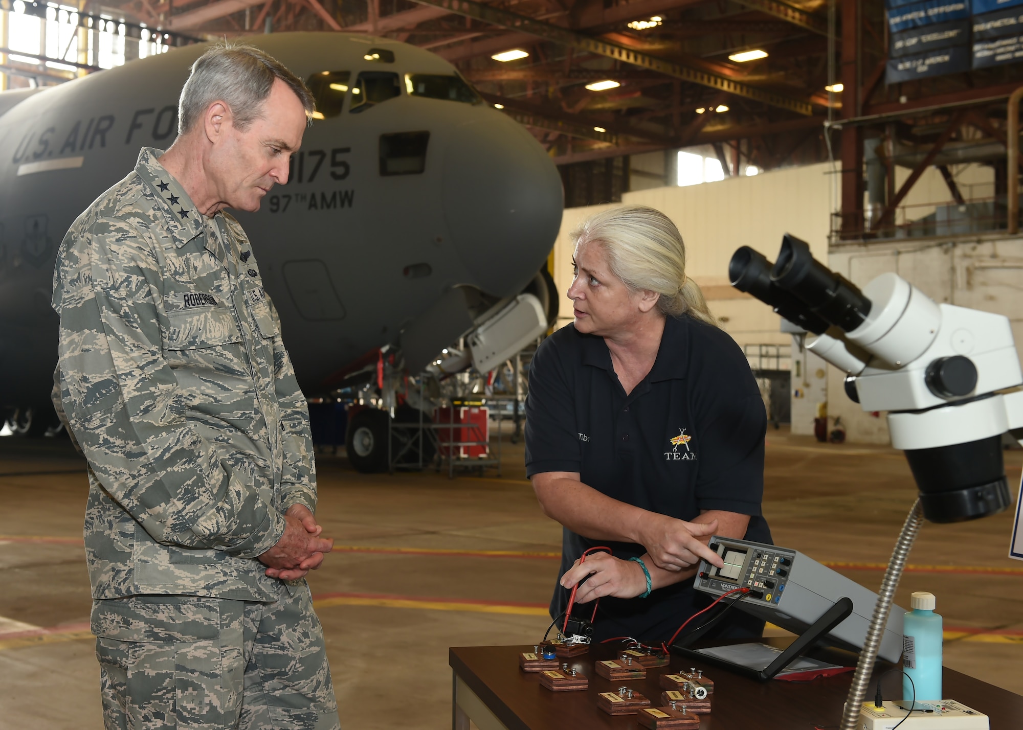 Dawn Tabor, 97th Maintenance Directorate electronic integrated systems mechanic, demonstrates a communication device that is used in an aircraft for U.S. Air Force Lt. Gen. Darryl Roberson, commander of Air Education Training Command, April 26, 2016 at Altus Air Force Base, Okla. Roberson visited Altus AFB to gain a better understanding of the base’s training mission and discuss Air Force topics, including the U.S. Air Force KC-46 Pegasus, the importance of AETC missions and the need for innovation in the U.S. Air Force.  (U.S. Air Force photo by Airman 1st Class Kirby Turbak/Released)