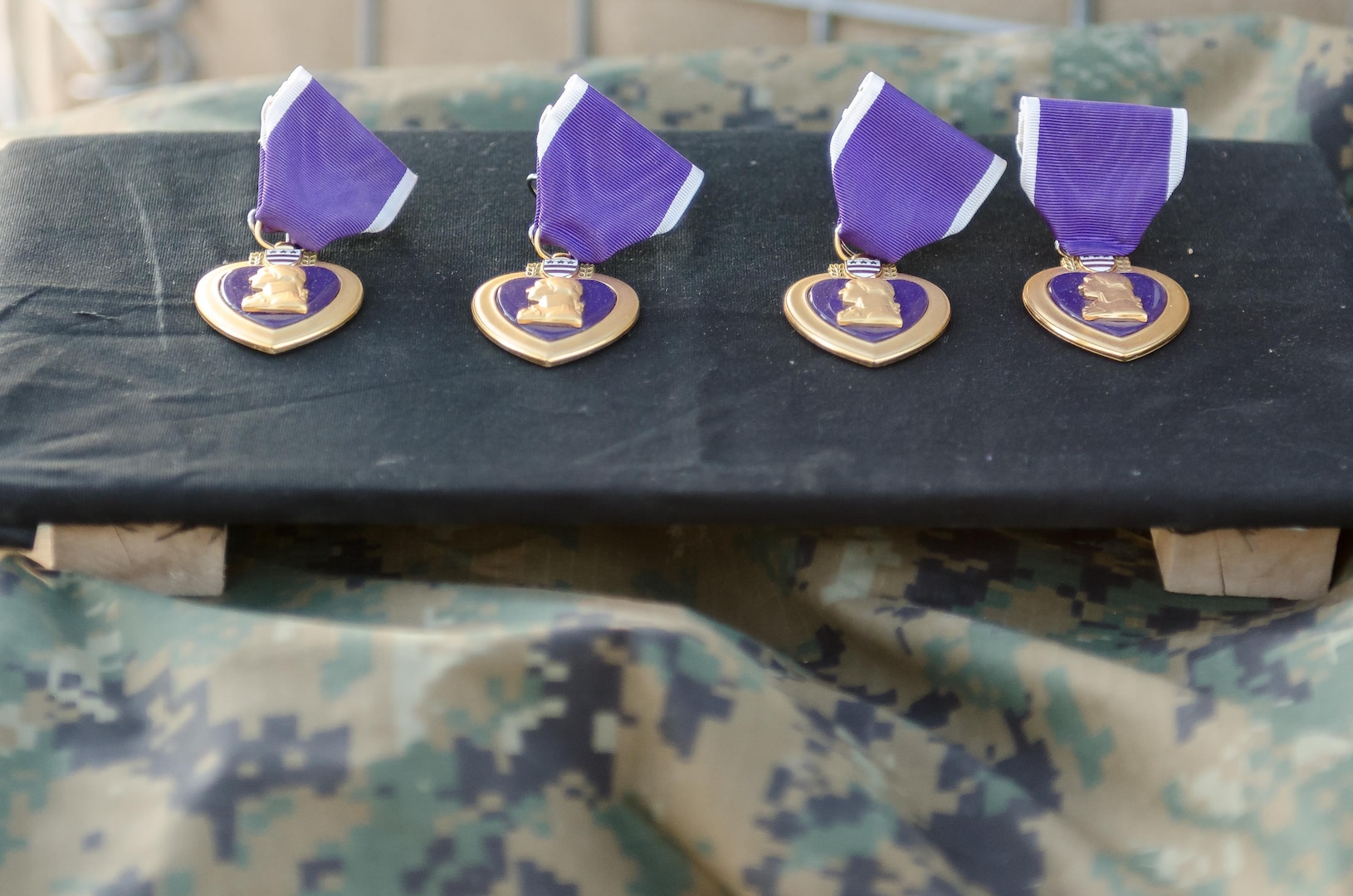 The Purple Heart was established by Gen. George Washington at Newburgh, New York, Aug. 7, 1782, during the Revolutionary War. It was reestablished by the President Herbert Hoover in 1932 and is now awarded in the name of the president to U.S. service members who are wounded or killed in combat. These four medals were presented to U.S. Marines Cpl. Adam J. Seanor, a native of Montgomery, Pennsylvania, Cpl.  William Crisostomosfelipe, a native of Orange, California, Lance Cpl. Eli Cisco, a native of Mingo, West Virginia and Lance Cpl. Javier A. Suarezmontalvo, a native of Orange, Florida,  during a ceremony at Kara Soar Base, Makhmur, Iraq, April 22, 2016. The Marines, all field artillery cannon crewmen assigned to Battery E, 26th Marine Expeditionary Unit, were awarded their Purple Hearts at the very site they were wounded. (U.S. Army Photo by Staff Sgt. Peter J. Berardi)