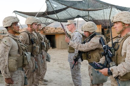 Chairman of the Joint Chiefs of Staff Gen. Joseph Dunford listens to award orders being read as he prepares to present Purple Hearts to U.S. Marines Cpl. Adam J. Seanor, a native of Montgomery, Pennsylvania, Cpl.  William Crisostomosfelipe, a native of Orange, California, Lance Cpl. Eli Cisco, a native of Mingo, West Virginia and Lance Cpl. Javier A. Suarezmontalvo, a native of Orange, Florida, during a ceremony at Kara Soar Base, Makhmur, Iraq, April 22, 2016. The Marines, all field artillery cannon crewmen assigned to Battery E, 26th Marine Expeditionary Unit, were awarded Purple Hearts at the very site they were wounded. (U.S. Army Photo by Staff Sgt. Peter J. Berardi)