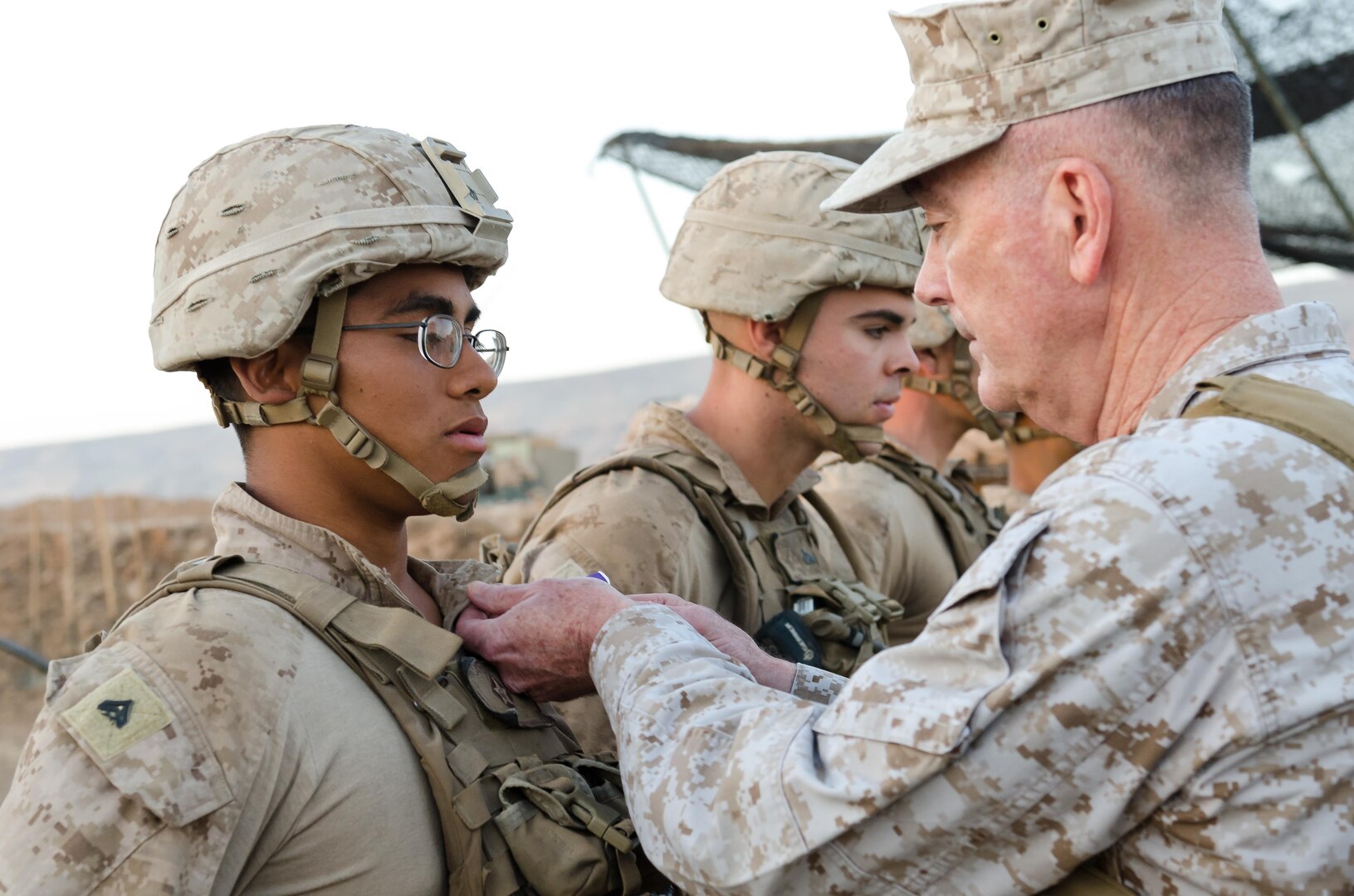 Chairman of the Joint Chiefs of Staff Gen. Joseph Dunford presents U.S. Marine Cpl.  William Crisostomosfelipe, a native of Orange, California, with the Purple Heart during a ceremony at Kara Soar Base, Makhmur, Iraq, April 22, 2016. Crisostomosfelipe, a field artillery cannon crewman assigned to Battery E, 26th Marine Expeditionary Unit, was awarded his Purple Hearts at the very site he was wounded March 19. (U.S. Army Photo by Staff Sgt. Peter J. Berardi)