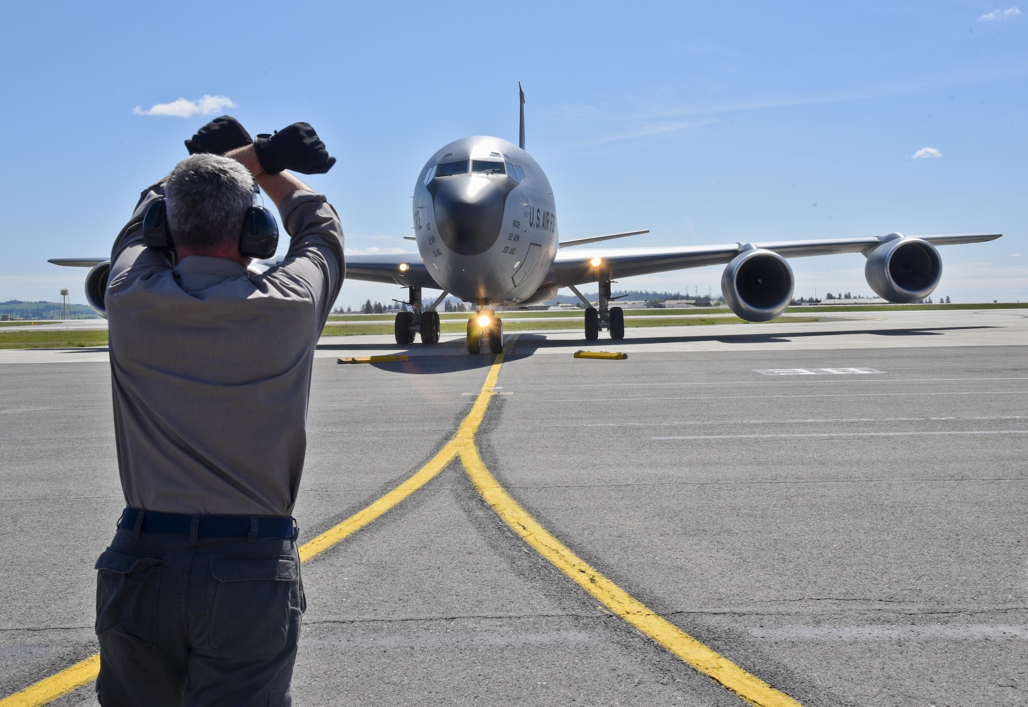 Kenneth Goulding, a 92nd Maintenance Squadron transient alert aircraft servicer, taxies in a KC-135 Stratotanker from McConnell Air Force Base, Kan., April 26, 2016, at Fairchild AFB, Wash. Because of its ramp space, logistical capabilities and maintenance facilities, Fairchild AFB received six KC-135 Stratotankers that were evacuated from McConnell AFB due to projected severe weather. (U.S. Air Force photo/Airman 1st Class Taylor Bourgeous) 