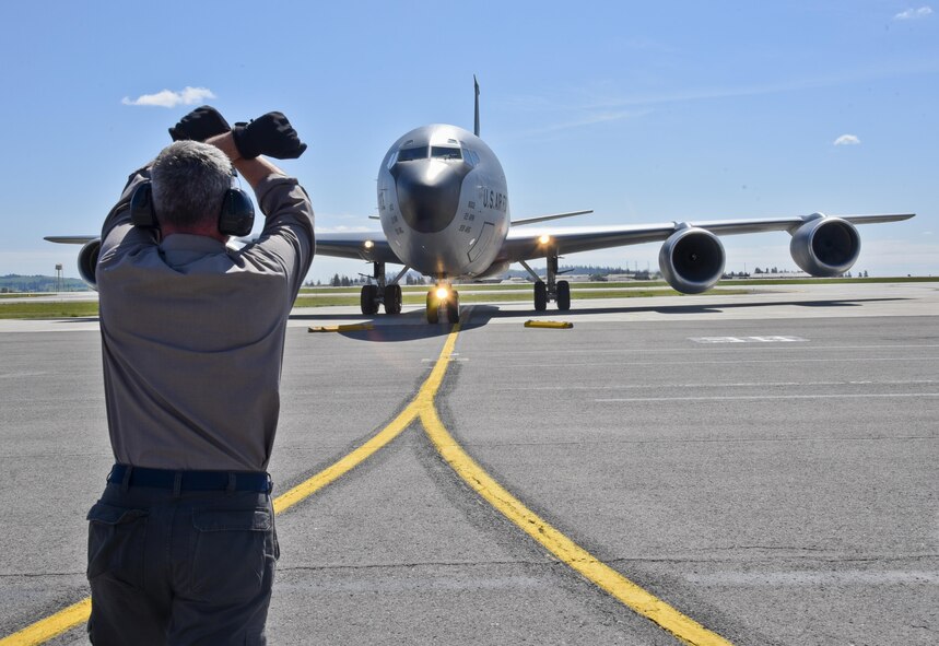 Kenneth Goulding, a 92nd Maintenance Squadron transient alert aircraft servicer, taxies in a KC-135 Stratotanker from McConnell Air Force Base, Kan., April 26, 2016, at Fairchild AFB, Wash. Because of its ramp space, logistical capabilities and maintenance facilities, Fairchild AFB received six KC-135 Stratotankers that were evacuated from McConnell AFB due to projected severe weather. (U.S. Air Force photo/Airman 1st Class Taylor Bourgeous) 