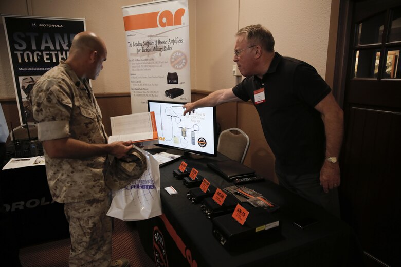 Master Sgt. Robert Robinson, operations chief, Marine Corps Tactics and Operations Group, looks at booster and network radio amplifiers made by AR Modular RF at the Officers’ Club during the Tactical and Technology Day Expo April 19, 2016. (Official Marine Corps photo by Pfc. Dave Flores/Released)