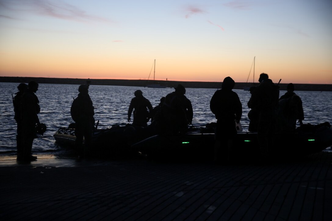 Marines with Company A, 1st Reconnaissance Battalion, 1st Marine Division, wait to advance to their objective during an amphibious operations training exercise as part of an Expeditionary Operations Training Group course at Camp Pendleton April 21, 2016. During the course, the Marines conducted amphibious operations training exercise to prepare for their deployment with the 11th Marine Expeditionary Unit in the near future. (U.S. Marine Corps Photo by Cpl. Demetrius Morgan/RELEASED)