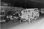 Trucks of the 179th Field Artillery, 48th Armored Division loaded full of troops move out from the Atlanta Armory during Operation Minuteman on April 27, 1955..