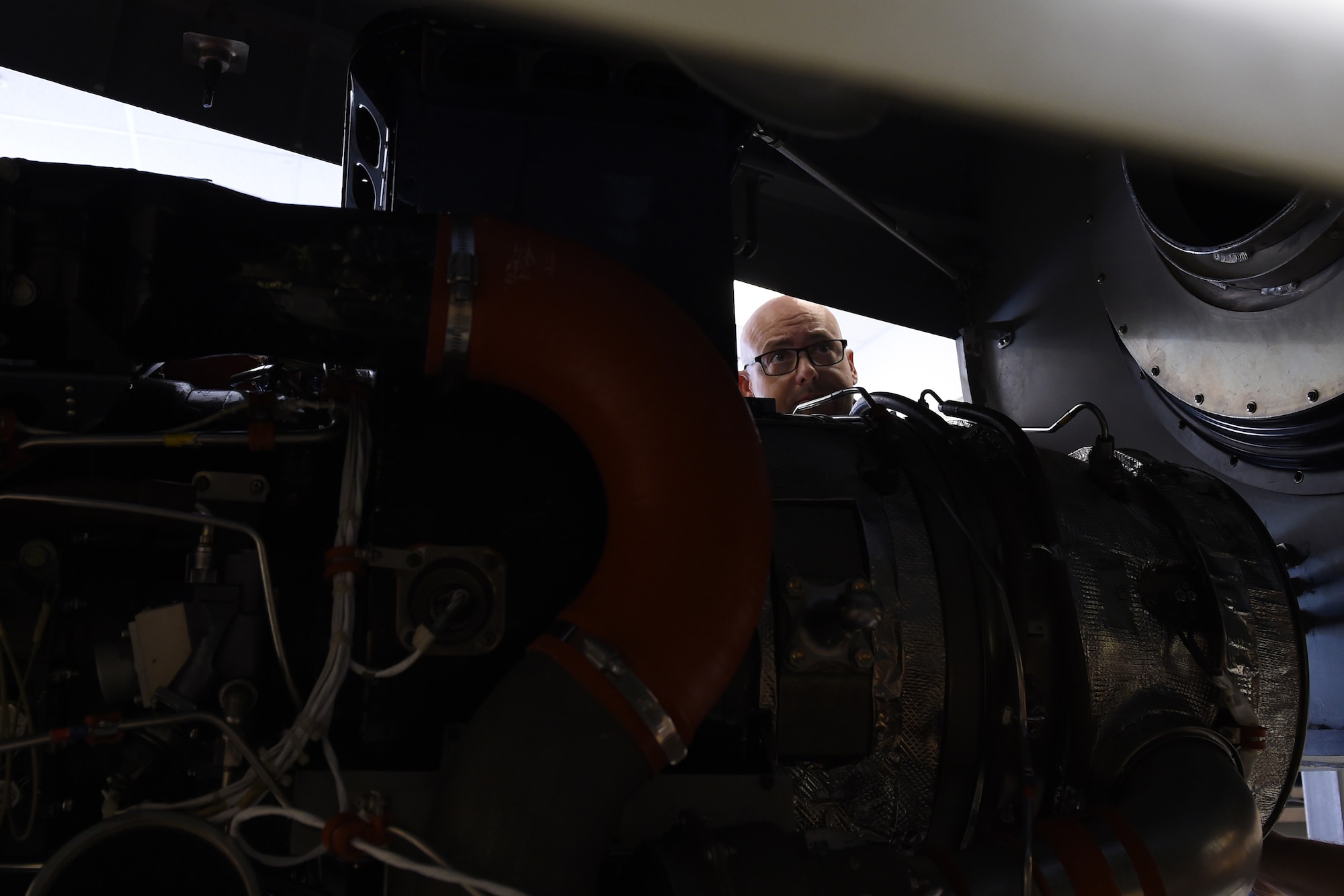 Sgt. Brad Kay, Royal Australian Air Force 36th Squadron aircraft technician, guides a C-17 Globemaster III aircraft auxiliary power unit into place April 19, 2016, during a class at the 373rd Training Squadron Detachment 12 at Joint Base Lewis-McChord, Wash. Kay is part of a class of six Airmen from the Royal Australian Air Force being trained at the detachment. (U.S. Air Force photo/Senior Airman Jacob Jimenez) 