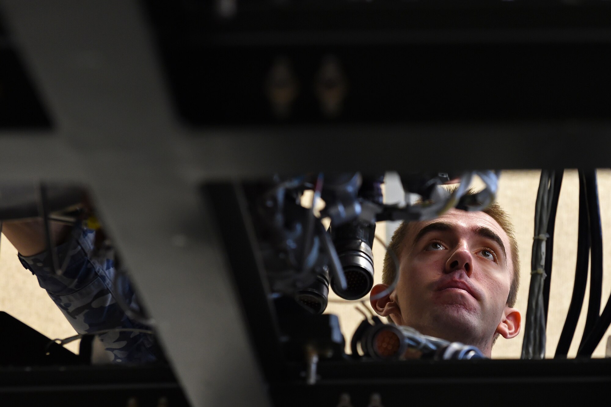 Aircraftsman Aaron Kouyoumtzoglou, Royal Australian Air Force 36th Squadron aircraft technician, reconnects an auxiliary power unit to a C-17 Globemaster III aircraft trainer April 19, 2016, at Joint Base Lewis-McChord, Wash. The auxiliary power units is used to start a C-17’s four jet engines and provide power to the plane during flight. (U.S. Air Force photo/Senior Airman Jacob Jimenez) 
