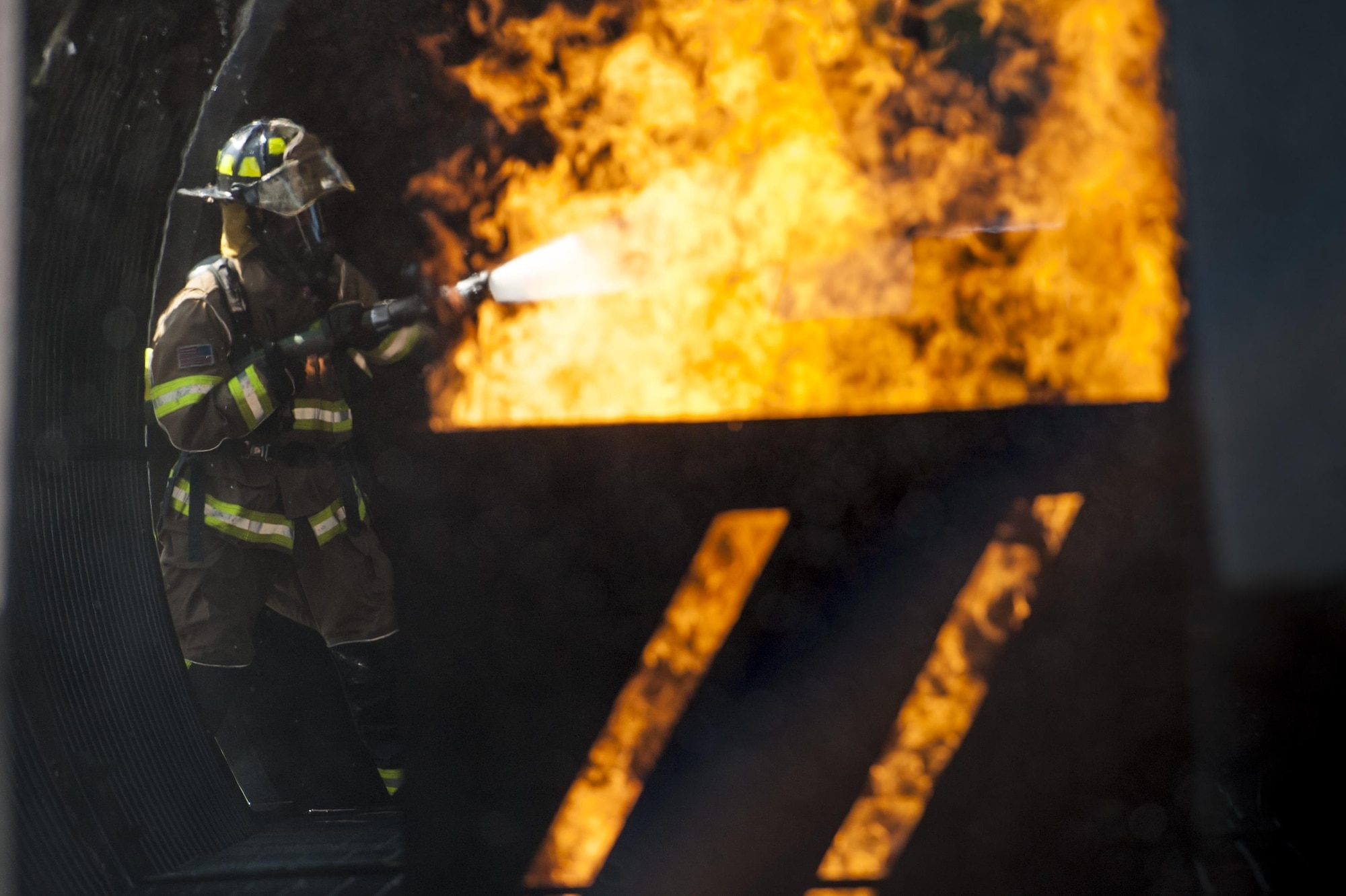 A firefighter from the 23d Civil Engineer Squadron puts out an engine fire during aircraft live fire training, April 27, 2016, at Moody Air Force Base, Ga. During the training exercise, Airmen practiced the proper techniques to extinguish a jet fuel fire in the case of an aircraft incident. (U.S. Air Force photo by Airman 1st Class Lauren M. Hunter/Released)