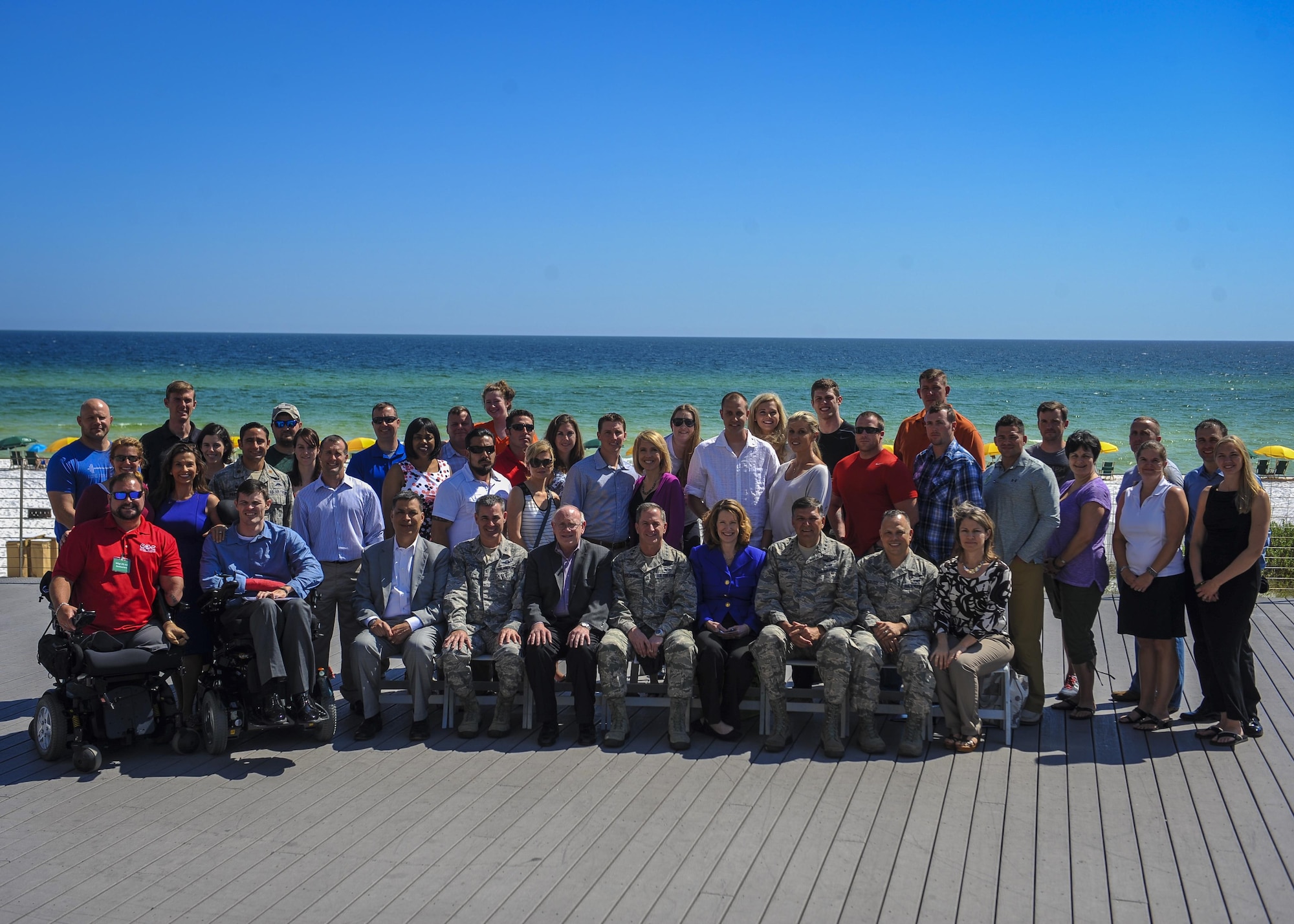 Attendees of the Air Force Special Operations Command Warrior C.A.R.E. Summit gather for a group photo with distinguished visitors at the Hilton Sandestin Beach Golf Resort & Spa April 26, 2016. The summit was designed to give wounded, injured and ill service members and caregivers an opportunity to discover available resources, network with helping agencies, develop mentor relationships and expand their life skills. (U.S. Air Force photo by Senior Airman Meagan Schutter) 