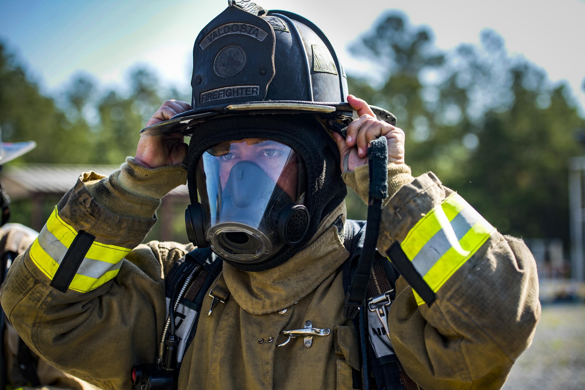 Shelley Miller, Valdosta Fire Department sergeant, gears up during aircraft live fire training, April 27, 2016, at Moody Air Force Base, Ga. Firefighters broke into groups and took turns combating the fire as they would in the field. (U.S. Air Force photo by Airman 1st Class Janiqua P. Robinson/Released)