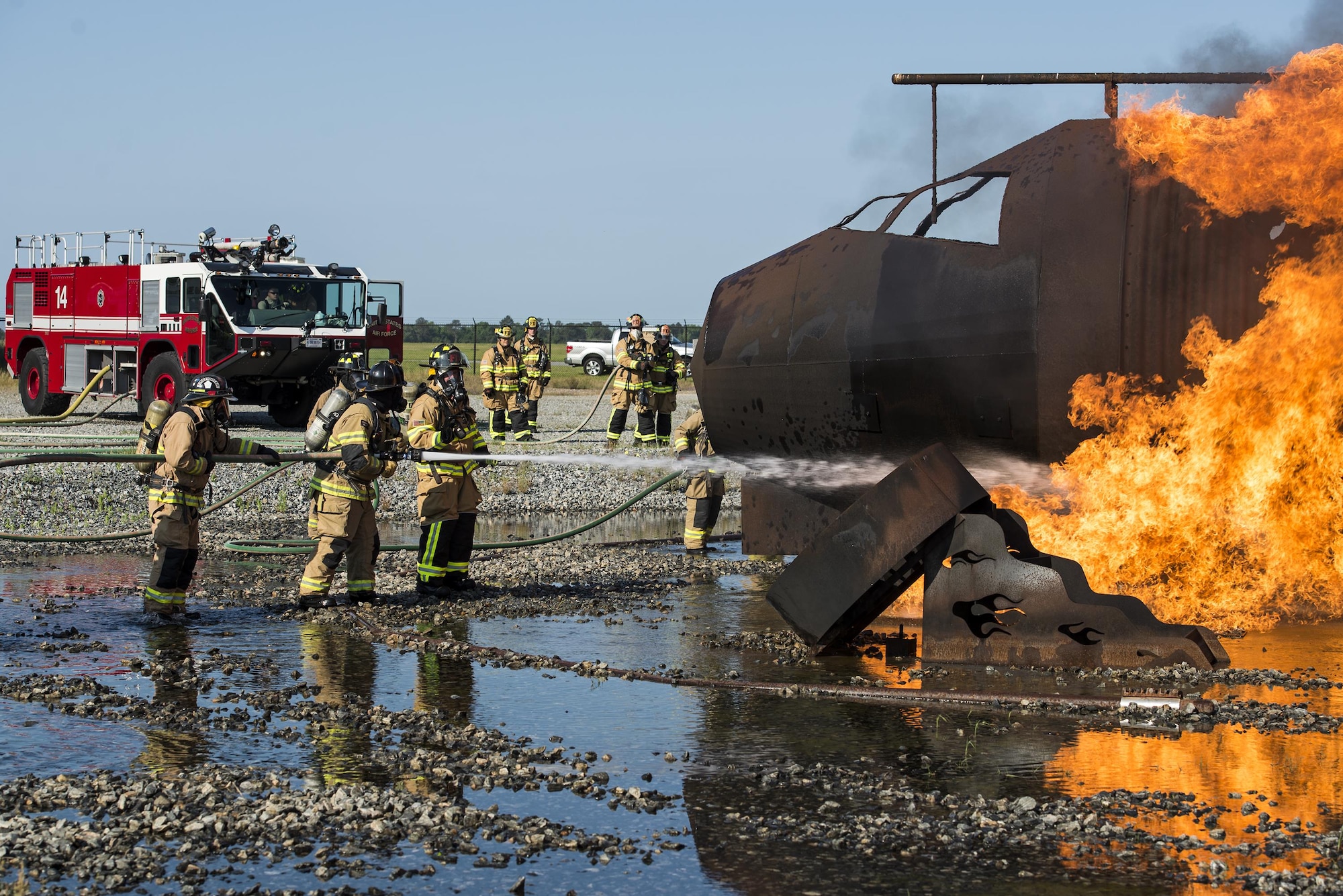 Firefighters from the Valdosta Fire Department and Moody’s Civil Engineer Squadron practice water-spraying techniques during aircraft live fire training, April 26, 2016, at Moody Air Force Base, Ga. Firefighters are required to conduct this training twice a year. (U.S. Air Force photo by Airman 1st Class Janiqua P. Robinson/Released)