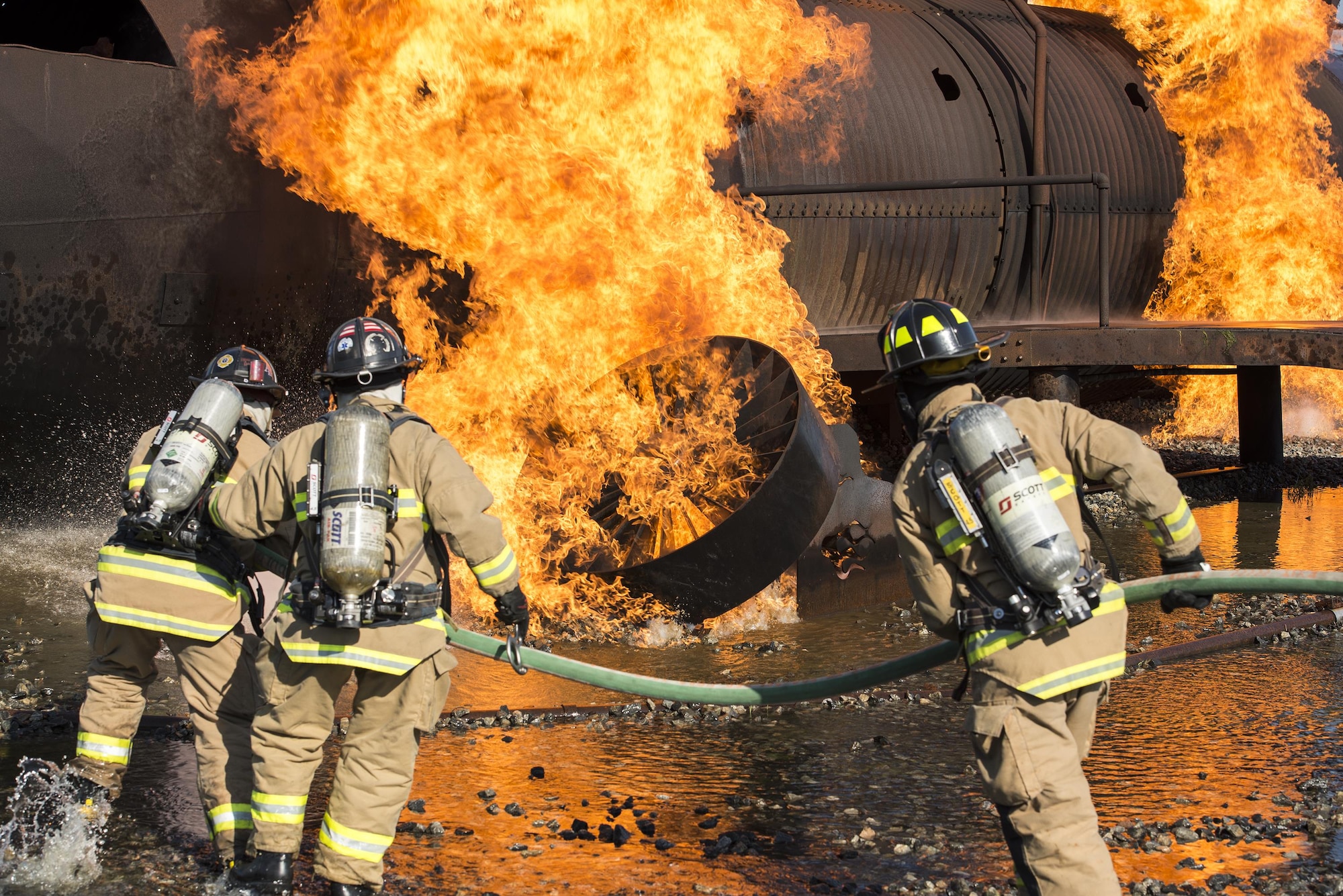 Firefighters from the Valdosta Fire Department rush towards a fire, April 26, 2016, at Moody Air Force Base, Ga. The Federal Aviation Administration requires VFD firefighters to complete aircraft live fire training twice a year. (U.S. Air Force photo by Airman 1st Class Janiqua P. Robinson/Released)