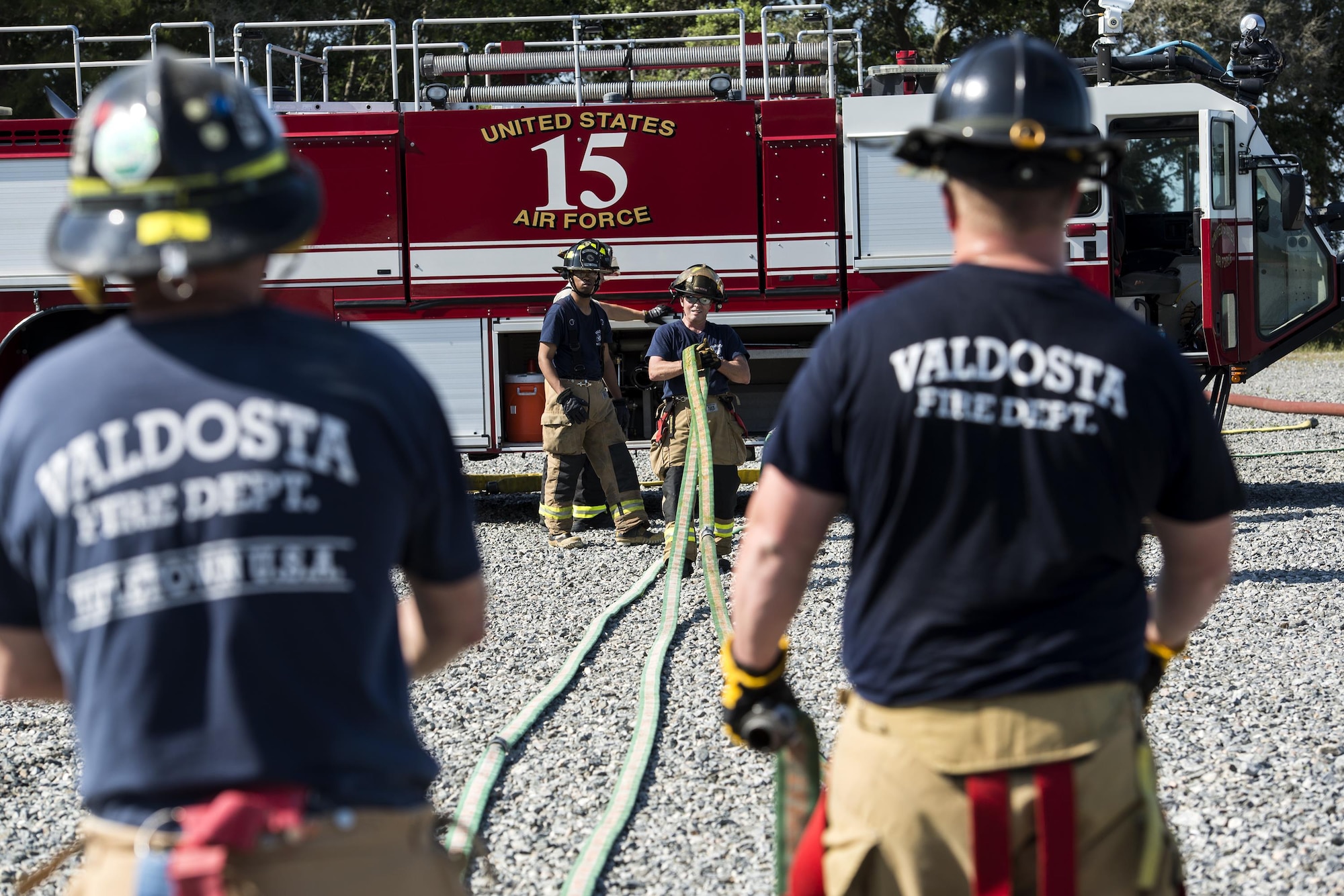 Firefighters from the Valdosta Fire Department put equipment away after aircraft live fire training, April 26, 2016, at Moody Air Force Base, Ga. Moody’s fire department and the VFD use similar equipment, which makes training and working together easier. (U.S. Air Force photo by Airman 1st Class Janiqua P. Robinson/Released)