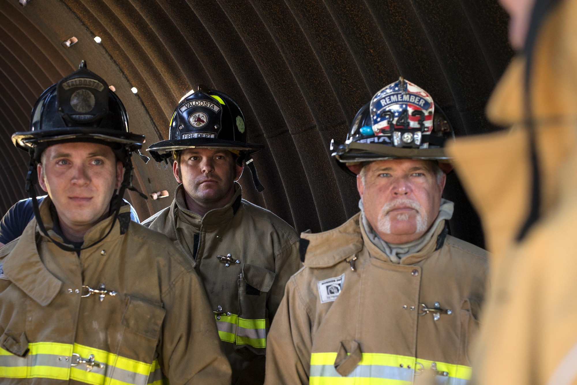 Firefighters from the Valdosta Fire Department listen to a mission brief during a walkthrough of the day’s events before aircraft live fire training April 26, 2016, at Moody Air Force Base, Ga. Firefighters were able to see the inside of the training prop and received guidance on where the sources of the fires were, and what type of techniques to use while putting them out. (U.S. Air Force photo by Airman 1st Class Janiqua P. Robinson/Released)