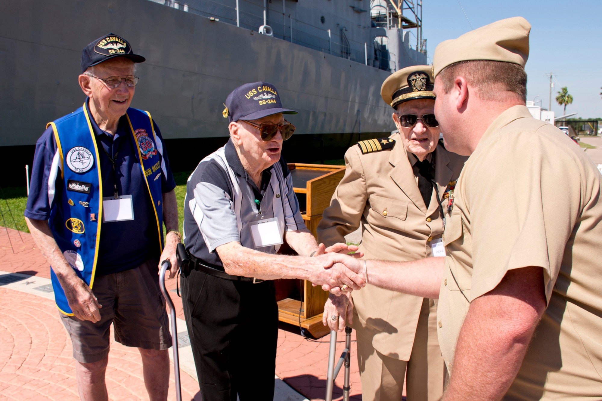 U.S. Navy Master Chief Petty Officer Mike Altrogge, shakes hands with former Fire Controlman 2nd Class John Breslin, during the “All Cavalla Reunion Memorial Service” at Seawolf Park in Galveston, Texas, Apr. 23, 2016. Breslin, Don Haseley and Capt. Zeke Zellmer, are three of the remaining five original members of the USS Cavalla (SS 244) from World War II. Altrogge was assigned to the USS Cavalla (SSN 684) from 1996-1999. The bi-annual reunion is an opportunity for former crewmembers of the USS Cavalla SS - SSK - AGSS - 244 and USS Cavalla (SSN 684) to reconnect with each other, make new friends, share sea stories and honor the memory of those submariners who have passed. (Courtesy photo by Jeff Walston)  