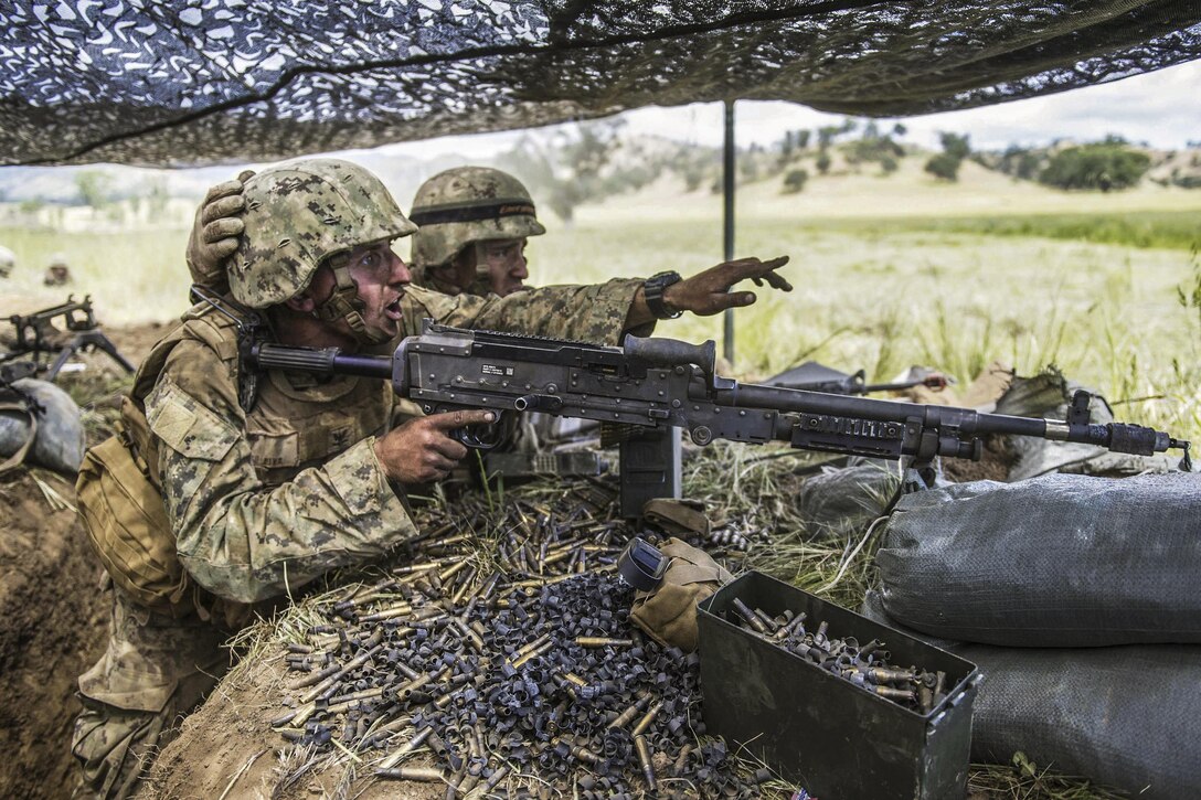 A Seabee yells out enemy locations to his teammates during a simulated attack as part of a field training exercise at Fort Hunter Liggett, Calif., April 27, 2016. The exercise prepares and tests a battalion's ability to enter hostile locations, build assigned construction projects and defend against enemy attacks in realistic scenarios. Navy photo by Petty Officer 3rd Class Stephen Sisle
