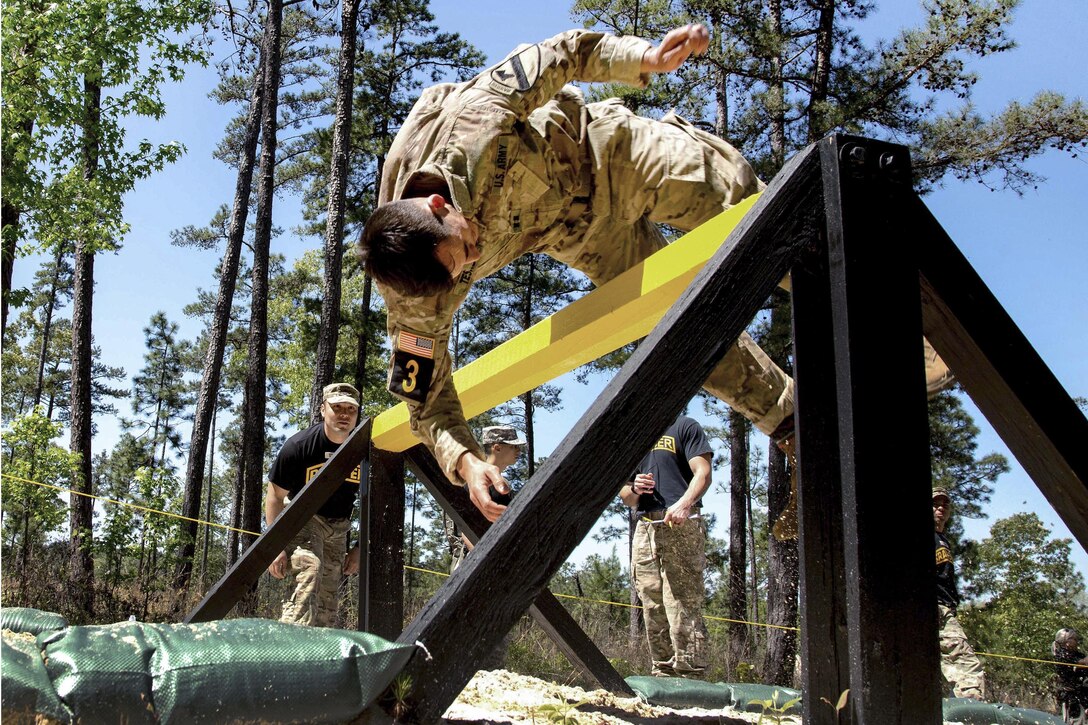 Army Capt. James Teskey dives over an obstacle on an obstacle course during Best Ranger Competition 2016 at Fort Benning, Ga., April 17, 2016. Teskey is assigned to the 2nd Infantry Division. Army photo by Spc. Steven Hitchcock
