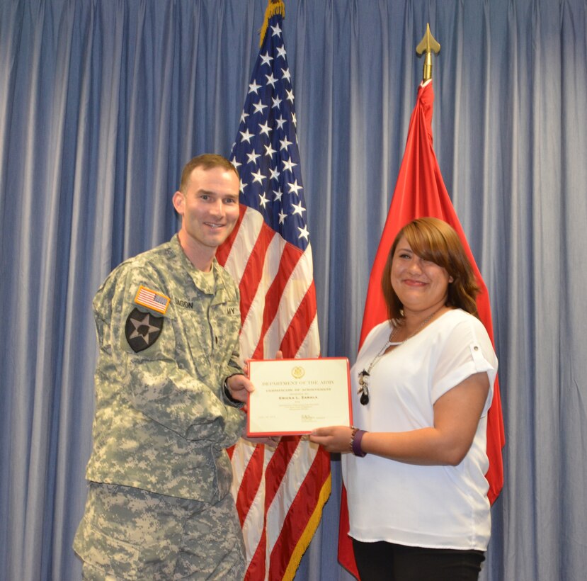 ALBUQUERQUE, N.M. – Ericka Zabala (right) receives a certificate of achievement from District Commander Lt. Col. Patrick Dagon, April 26, 2016. Zabala was recognized as the District’s 2016 Administrative Professional of the Year.  