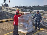 SINGAPORE (Apr. 21, 2016) – LS1 Joseph Lejos (right), Naval Supply Systems Command Fleet Logistics Center Yokosuka, Site Singapore (FLC), supervises the delivery of supply items to ships belonging to the USS John C. Stennis (CVN 74) Carrier Strike Group Apr. 21, 2016. Navy Region Center Singapore (NRCS) welcomed Sailors from the strike group during a port visit in Sembawang, Singapore, April 19-23, 2016. The FLC logistics team coordinates with supply officers onboard ships prior to their arrival in order to provide quality logistics services such as provisions, fuel, postal services, and pier-side support. As part of their regularly scheduled 7th Fleet deployment, the Sailors of the strike group took advantage of the region’s sports facilities and Terror Club along with other services such as participating in local tours, shopping at the Navy Exchange and utilizing Navy Federal Credit Union banking services. 