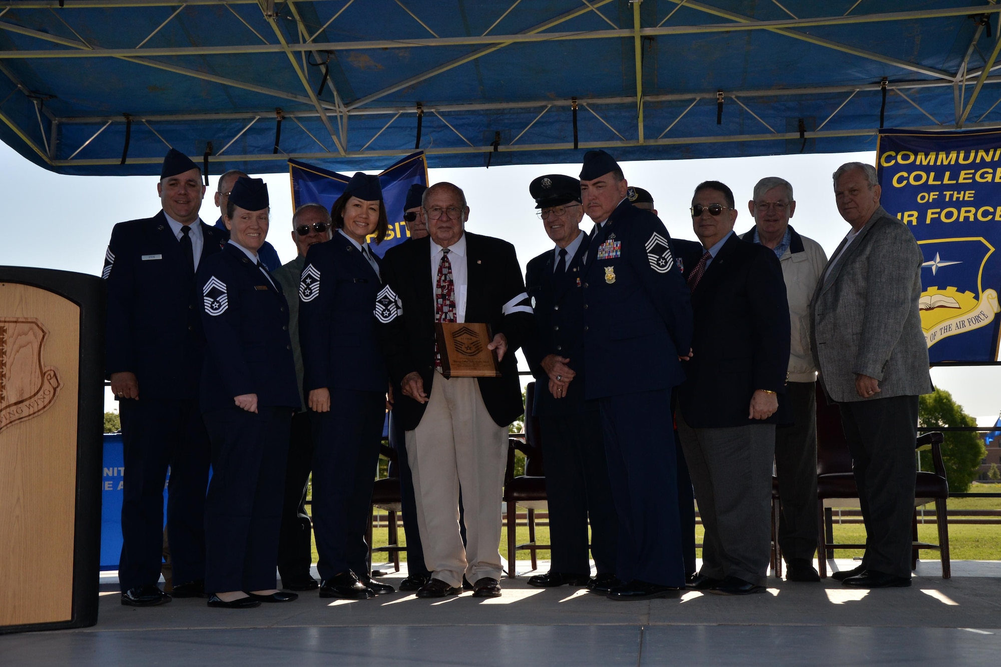 U.S. Air Force Col. Charlie E. Powell, retired, stands with all Goodfellow chief master sergeants after receiving an honorary induction on Goodfellow Air Force Base, Texas, April 28, 2016. Receiving an induction to the rank of chief master sergeant is one of the highest honors an enlisted group can bestow on a member. (U.S. Air Force photo by Randall A. S. Moose/Release)