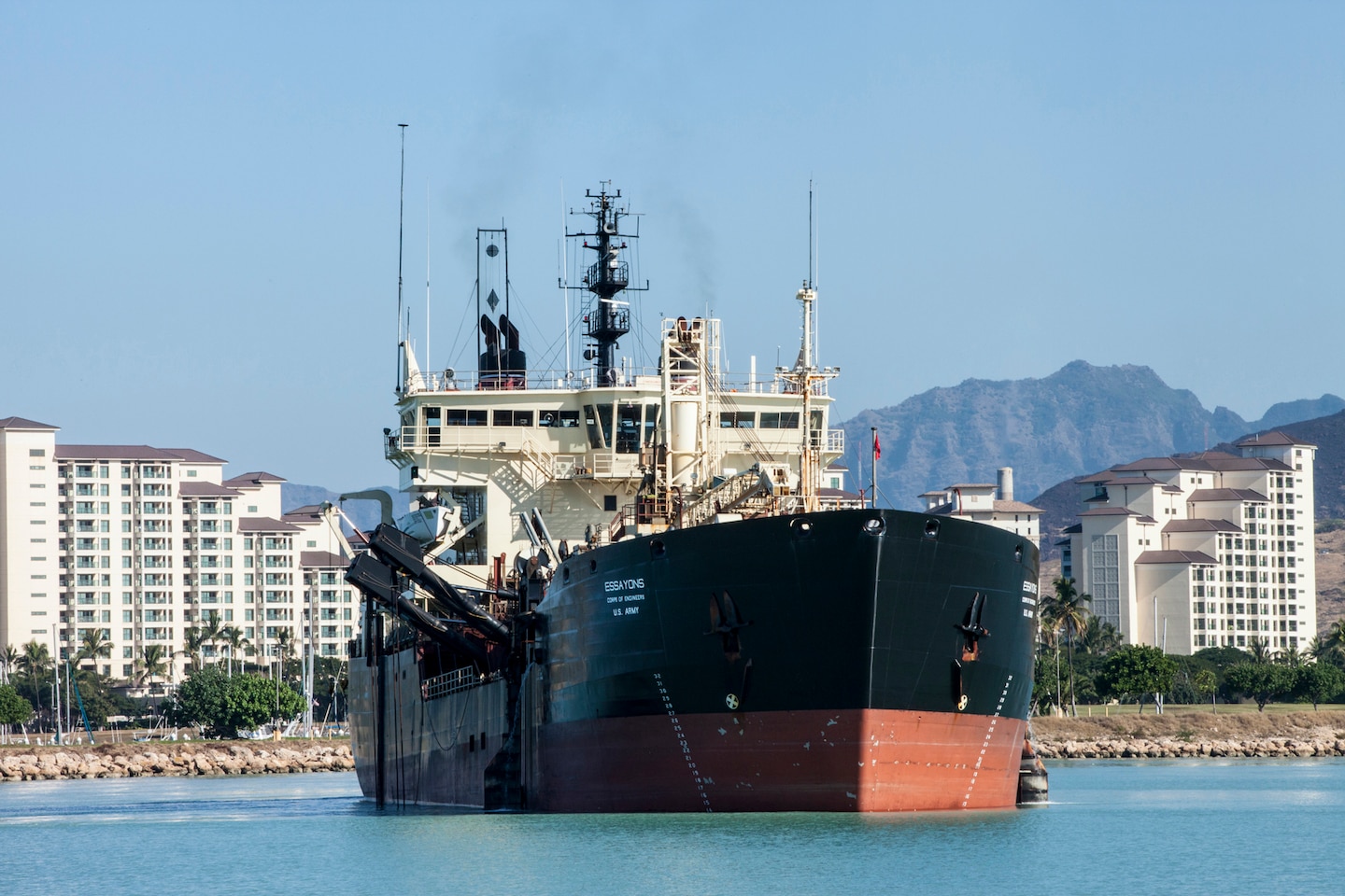 The U.S. Army Corps of Engineers’ hopper dredge Essayons just finished vital maintenance dredging of the federal navigation channels in Honolulu, Barbers Point (shown here), Kahului, Hilo, and Nawiliwili commercial harbors.  Hawaii is a maritime state over 2,400 miles from the mainland and far more dependent on its harbors than most of the United States. The Hawaii state DOT claims that over 80 percent of all consumer goods – food, clothing, autos, building supplies, machinery, paper, and allied products, medical supplies, and agricultural materials – are imported into the state. Of that 80 percent, approximately 98 percent enters Hawaii though commercial harbors on the major islands.  To ensure that these vital goods continue to arrive in Hawaii, the Essayons dredged approximately 300,000 cubic yards from the harbors and safely disposed of it at EPA-designated ocean disposal sites.  Special care was taken to protect marine life such as sea turtles.