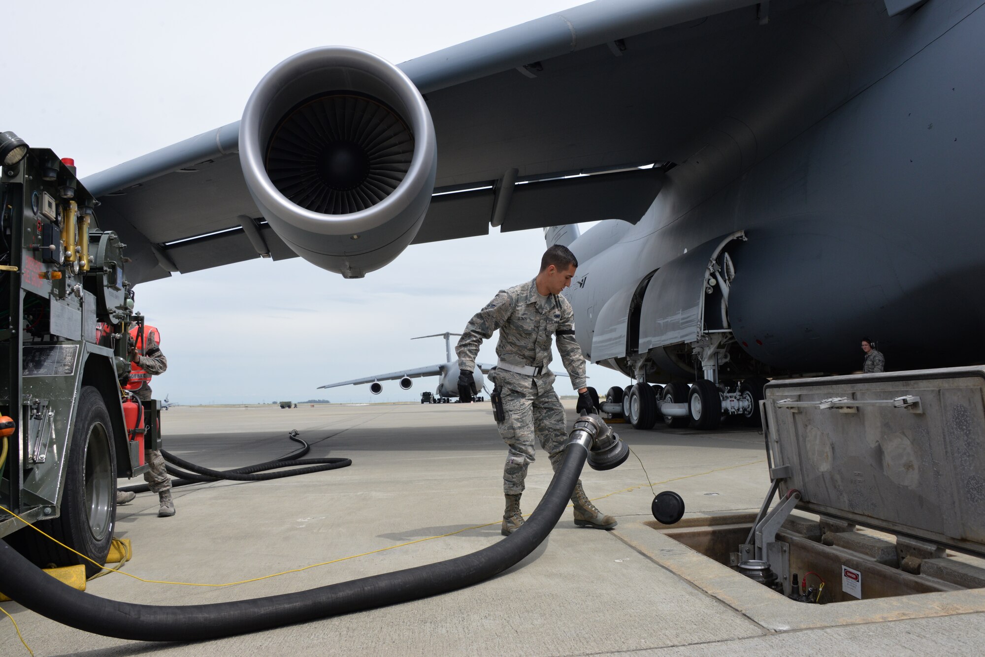 Airman 1st Class Connor Starr removes a fuel hose from a hydrant April 26 at Travis Air Force Base, Calif. Starr was refueling a C-5M Super Galaxy. (U.S. Air Force photo by Senior Airman Amber Carter)