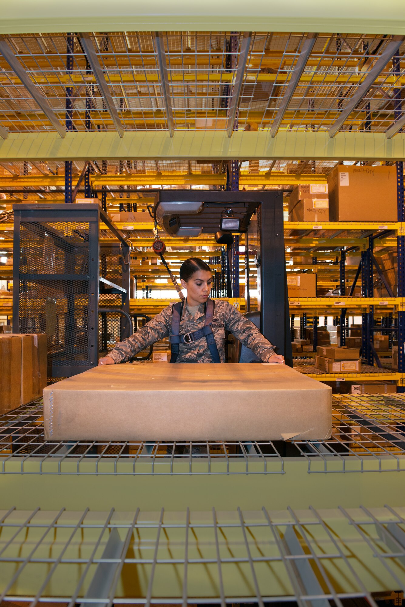 Airman 1st Class Megan Aguilar, 60th Logistics Readiness Squadron aircraft parts store, retrieves assets from bin row. (U.S. Air Force photo by Louis Briscese)